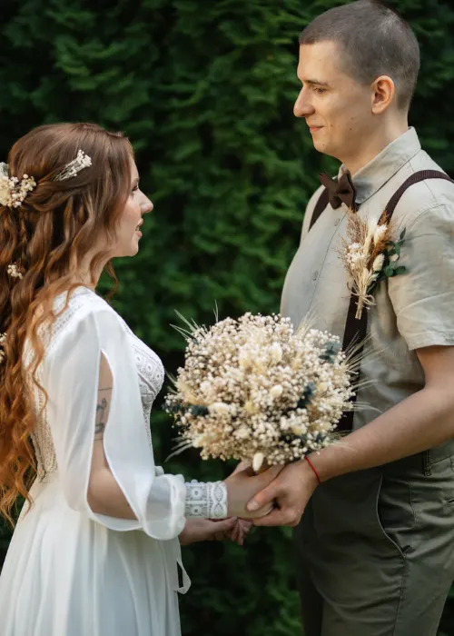 wedding walk of the bride and groom in a coniferous park in summer