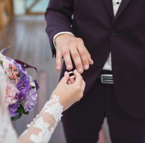Untitled design (9) The bride puts ring on groom's finger